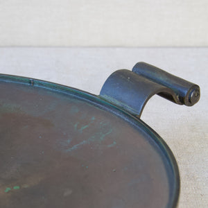 Detail of the scroll handle on a bronze platter designed by Einar & Sune Bäckström, Sweden, circa 1934.