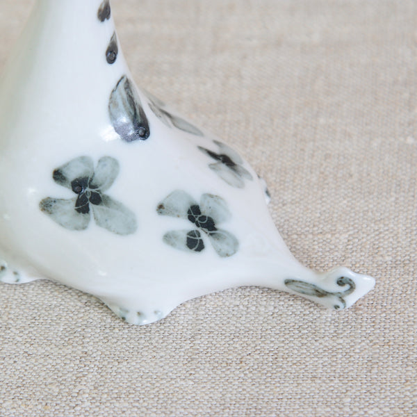 Close-up of the back and tail of a Loch Ness Monster collectable, Susan Parkinson porcelain Nessie designed for the Scottish gift market