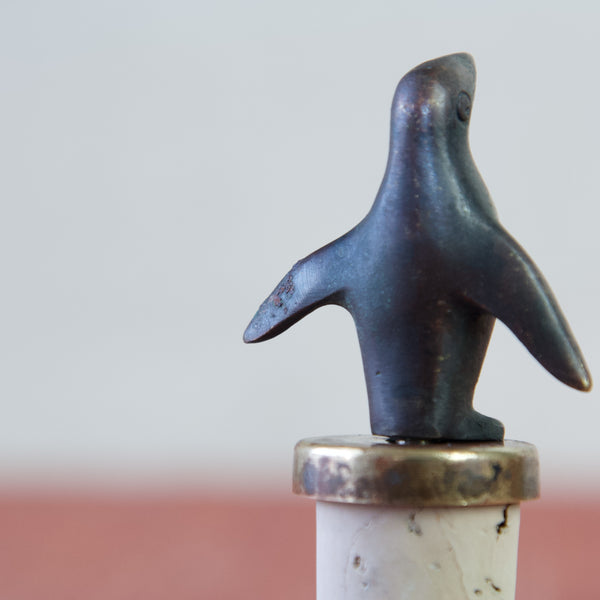 Detail of some oxidation on the flipper of a bronze or brass penguin figurine designed by Walter Bosee