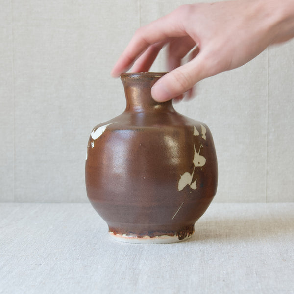 Brown stoneware vase by Jim Malone with abstract wax resist decoration. 