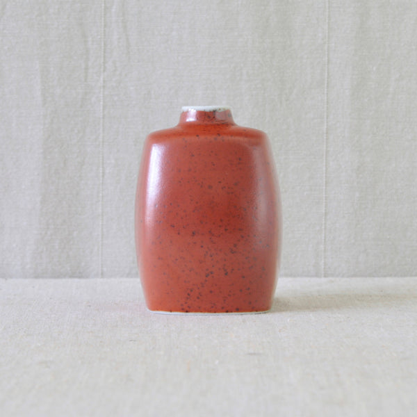 Side view of the small red glazed Danish Modern vase by Nils Thorsson
