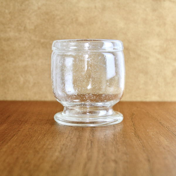 Profile images of a large goblet shaped vase in clear bubbled glass. This design is a Sargasso piece by Kaj Franck.