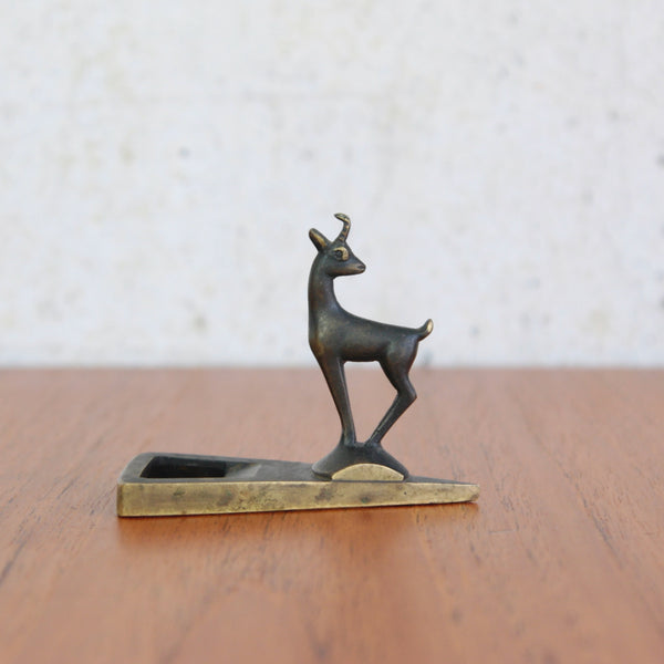Mid-century modern bottle opener by Richard Rohac, featuring a sculptural alpine goat in brass.