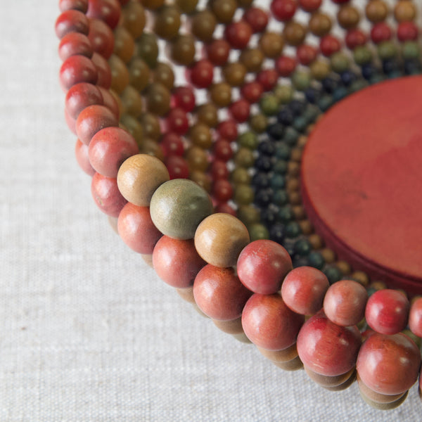 Detail of coloured beads on wooden handmade bowl, 1960's