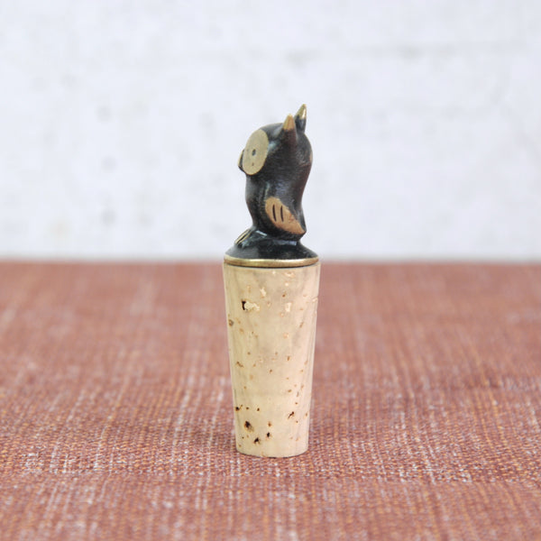 Decorative cork stopper with a small owl figure. This rare Walter Bosse owl bottle stopper was made in Vienna c.1950. Brass and cork bar accessory, a functional sculpture and collectible mid-century icon.