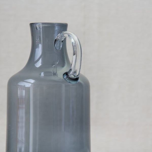 Kaj Franck model 1603 glass pitcher with air bubble handle, demonstrating the skill of Nuutajarvi glassblowers