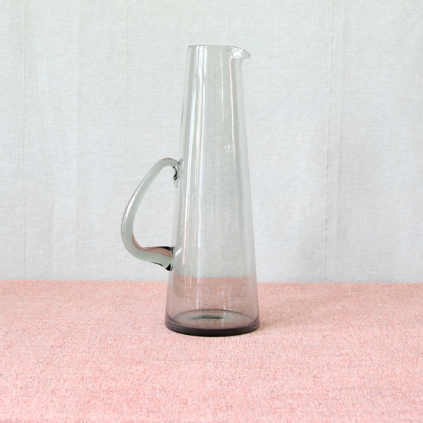 Tall, slender, conical vintage 1950’s Per Lütken ‘Martini’ pitcher jug. Hand blown in organic Modernist “Smoke” grey coloured glass, mid-century Danish barware design for Holmegaard glassworks.