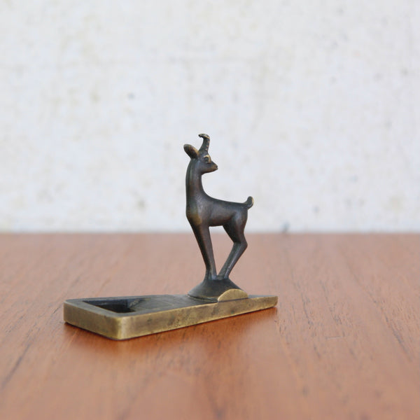 A sculptural brass bottle opener by Richard Rohac, featuring a detailed alpine goat figurine.
