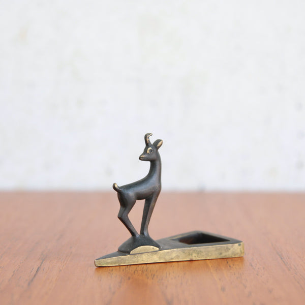 A Richard Rohac patinated brass chamois bottle opener in elegant mid-century modern style.