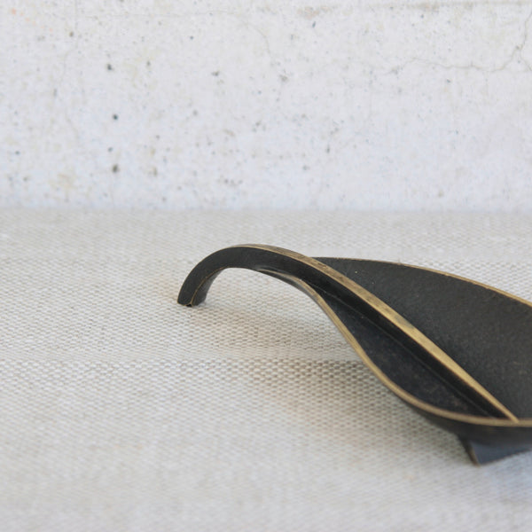 A Richard Rohac brass leaf-shaped tray with black patination, reflecting mid-century Vienna design.