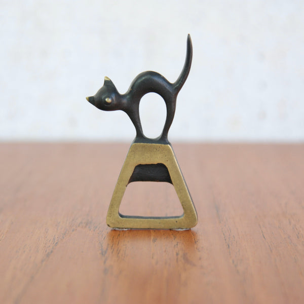 A sculptural Walter Bosse cat caplifter in patinated brass, produced by Baller Austria in Vienna during the mid-century era.