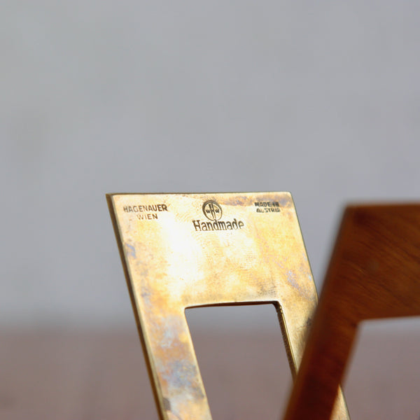 Close up detail shot showing all of the makers marks of Werkstätte Hagenauer, Vienna. These stamps are on a rare brass letter rack, elegant modernist accessory.