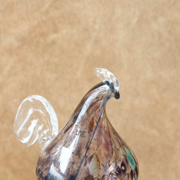 Detail showing the comb on a roosters head. This glass bird is the stopper of a "Kukkopullo" or “Rooster bottle” designed by Kaj Franck for Nuutajärvi glassworks, Finland. Classic Scandinavian design.