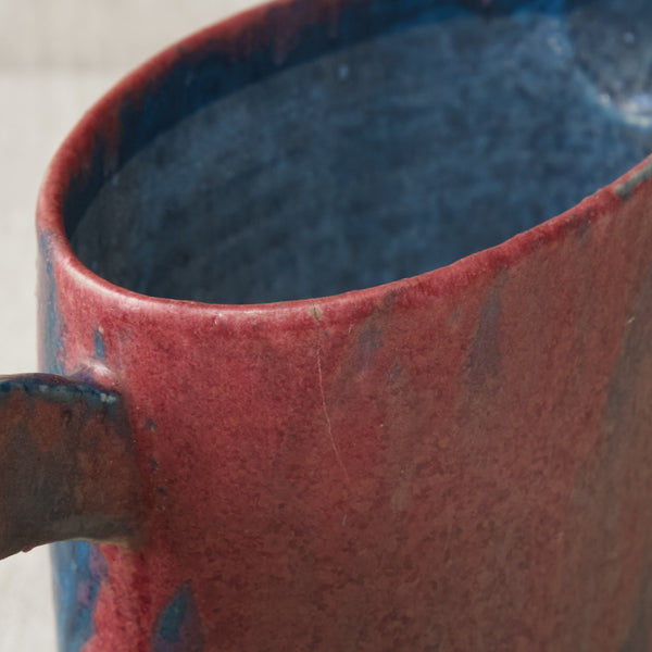 Zoomed in image showing the rim of a ceramic jug by Emmanuel Cooper jug. The vessel does contain a small 3cm long crack that travels downwards.