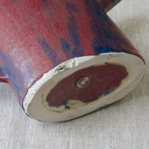 Detail shot showing the heel and foot of an Emmanuel Cooper jug. The experimental glaze clearly ran all the way to the bottom of the item and had to be chipped away to reveal a clean base.