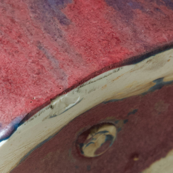 Detail of the edge of an Emmanuel Cooper jug's base. The glaze is thick and contains bubbles. Emmanuel Cooper made this jug circa 2000.
