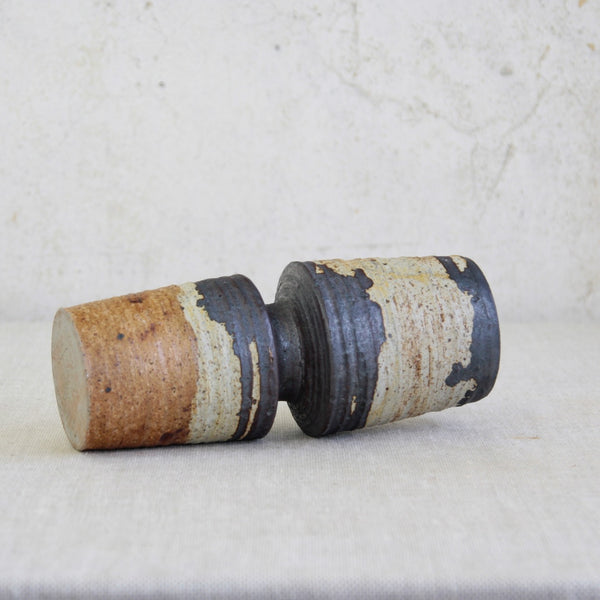 Mid-Century-Modern Studio Pottery Hourglass Vase with Iron-Rich Glaze., The vessel lays on its side in the photo. The Nordic design is by Finnish designer Annikki Hovisaari, for Arabia.