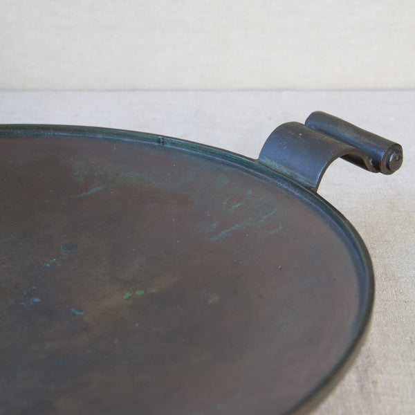 Artistic image showing the verdigris on a bronze platter with carrying handle. The design, inspired by neoclassicism and Art Deco Modernism, is part of the Swedish Grace Movement.