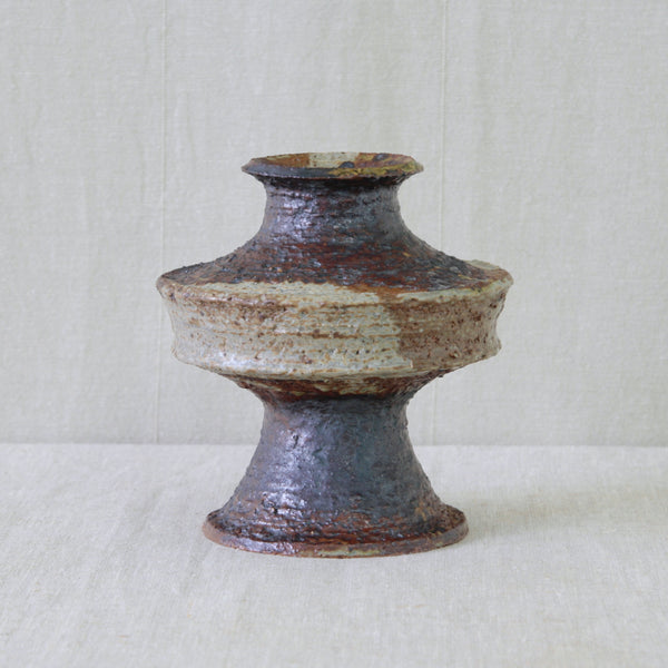 Annikki Hovisaari chamotte clay vase for Arabia Finland, with coarse exposed clay and freely applied ochre and chocolate-brown glaze.