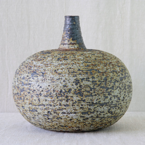 Unglazed vase by Annikki Hovisaari for Arabia, with areas of pale taupe stoneware deliberately left visible. Mid-Century Modernist heavily textured chamotte clay from Finland. 