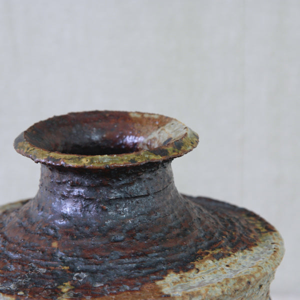 Detail image of ochre and brown glazed vase by Annikki Hovisaari for Arabia, a striking example of Scandinavian mid-century studio ceramics.