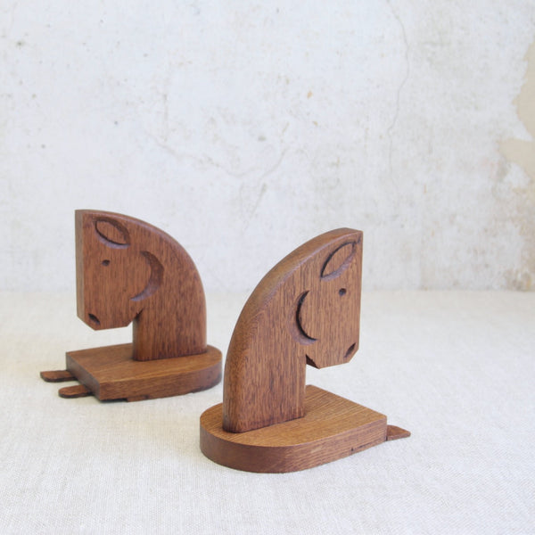 Vintage mid-century horse head bookends in solid oak, handmade in England and rich in natural texture.