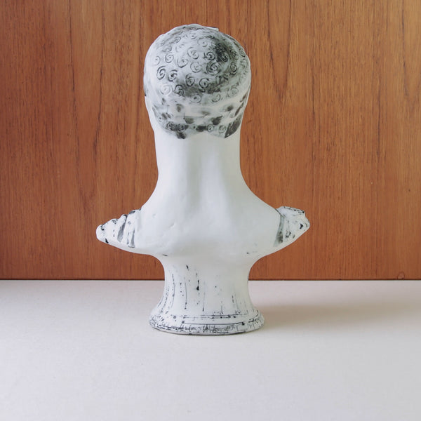 The backside of a large mid-century modern bust by Susan Parkinson depicting a classical Greek gentleman with laurel wreath and tunic, circa 1953.