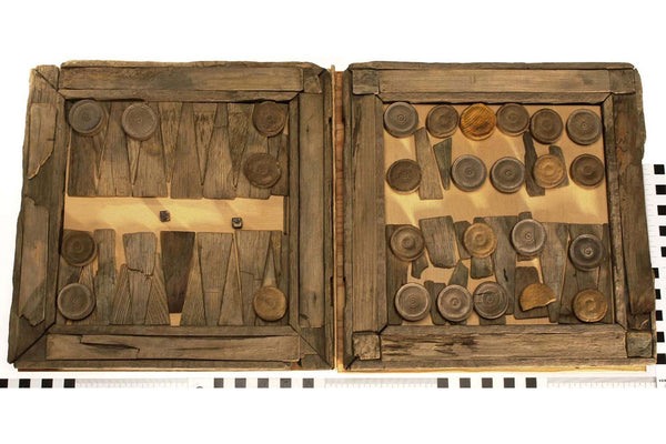 Image from the Vasa Museum Stockholm of a backgammon board discovered onboarded the warship Vasa. The shapes of the pieces could have inspired Tapio Wirkkala's special edition carving set which uses black oak salvaged from the 17th century warship Vasa.