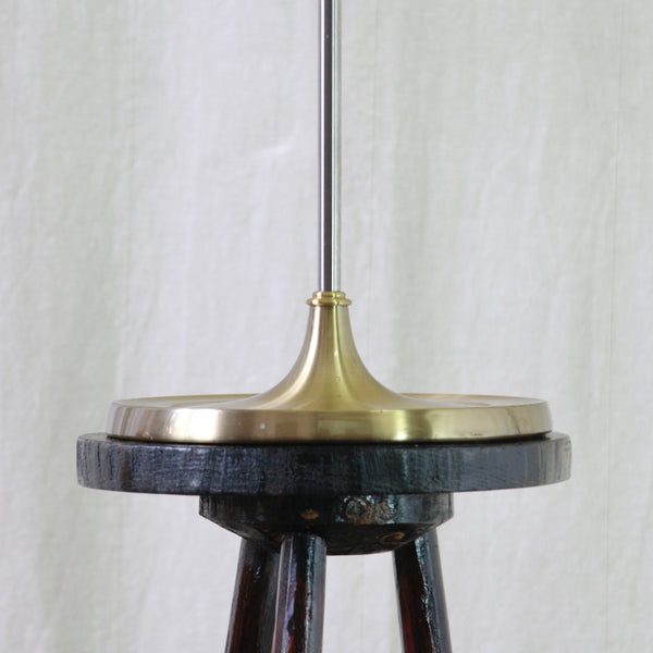 A close-up of the patinated brushed brass base of an Esben Klint Model 319 adjustable table lamp for Le Klint, Denmark, in stainless steel and brass.