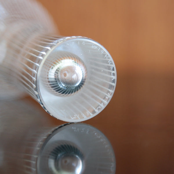 Detail of hand etched signature / makers marks on the based of a vintage Finnish Modernist glass vase by Tapio Wirkkala, model 3215 from the 'Varsanjalka' series, this examples is 16cm tall, available from the UK design gallery Art & Utility.