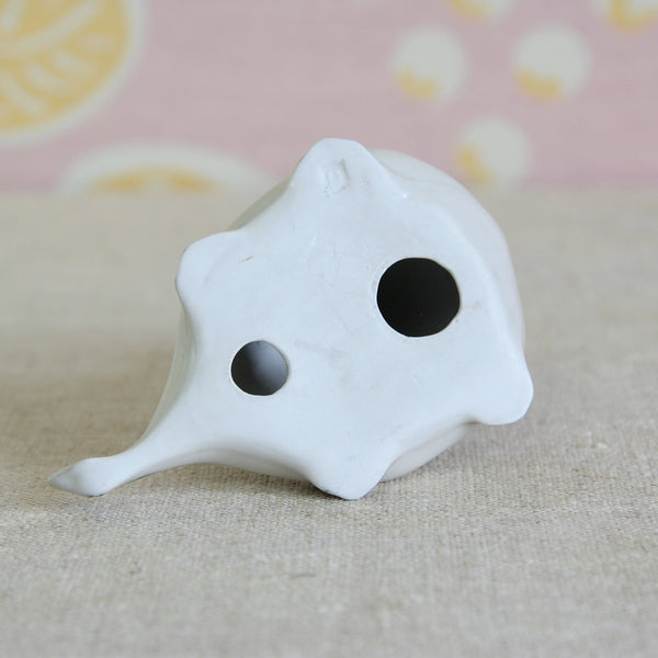 Base or underside of a collectable post-war British ceramic Nessie. Dating from the 1950's Susan Parkinson Loch Ness Monster sculpture features a small letter stamp impressed into the front right leg.