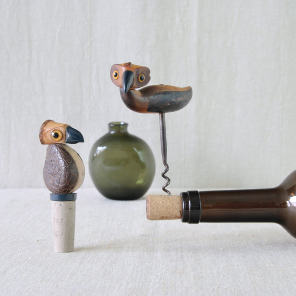 Two handcrafted wooden bird-shaped bar accessories with Bakelite beaks. Both designs are YZ birds, a corkscrew bottleopener and bottle stopper, designed by for Henry Howell & Co. 