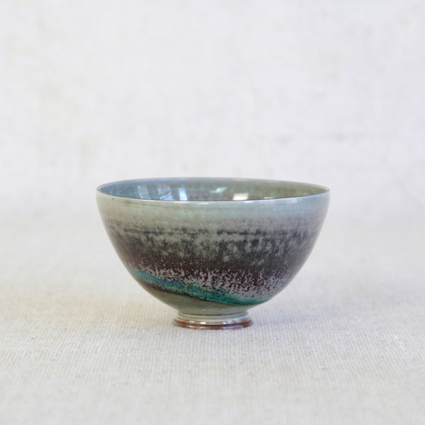 Angled top down shot of a deep aubergine-glazed Friberg bowl with sculptural form and refined craftsmanship; an iconic piece of mid-century Swedish ceramic design.