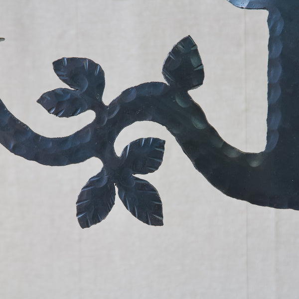 Detail of hand wrought iron handmade leaves on Bertil Vallien "Helicon" chandelier candelabra