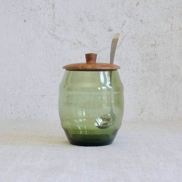 Glass and pine barrel-form storage jar designed by Erik Höglund for Boda, Sweden, circa 1960, combining hand-blown green glass with staved Swedish pine.