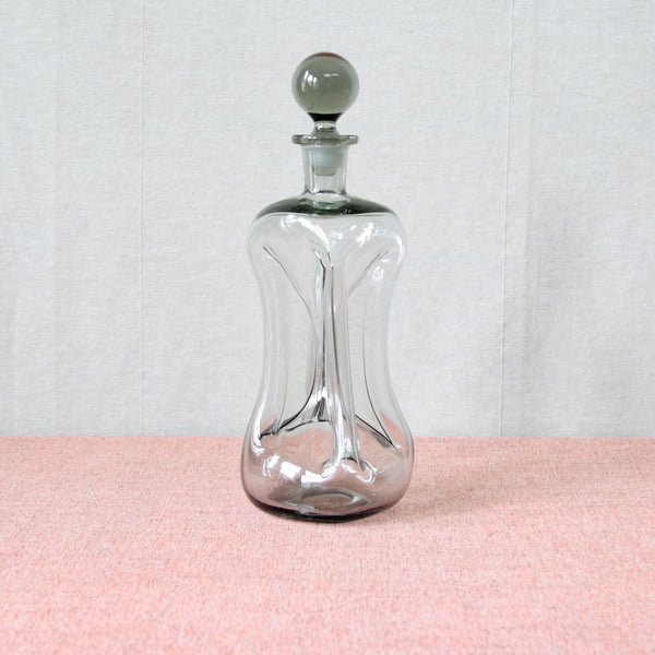 Elegantly classical Modernist 'Kluck Kluck’ (‘Cluck Cluck’) decanter bottle shaped reimagined by Jacob Bang in 1928 and then the coluur of this piece, “Smoke” grey, by Per Lütken circa 1965.  Collectible Danish design, produced by Holmegaard glassworks.