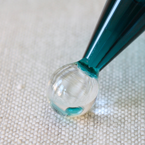 Clear glass ball knop on a Nanny Still Harlekiini lidded glass bowl, prized by collectors for its vibrant turquoise hue and precise geometric construction.