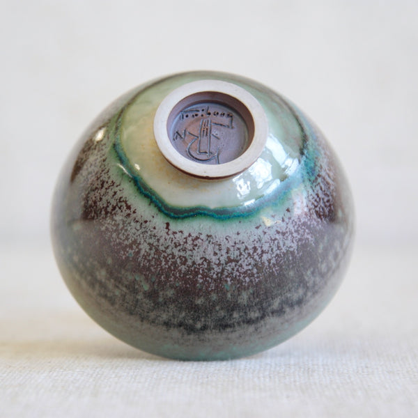 Close up of base or bottom of a Gustavsberg porcelain bowl by Friberg. The foot of the bowl is hand signed by Friberg and also features the Gustavsberg G and Hand that denotes it is a handmade studio piece. The letter N informs us that the item was made in 1972.