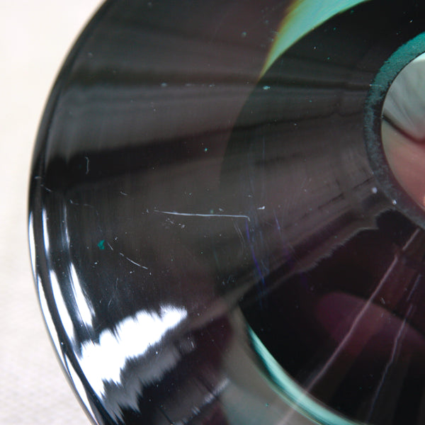 A close-up of small scratch to surface of Kaj Franck KF 235 Lentävä lautanen sculptural glass object, a distinctive work of post-war Finnish Modernism designed for Nuutajärvi in 1956.