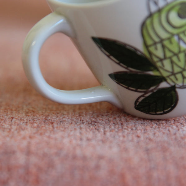 Zoomed in image showing the handle on a rare King pattern by Marianne Westman for Rörstrand, Sweden — this 1960s cup and saucer embodies the joy and elegance of mid-century Scandinavian style.