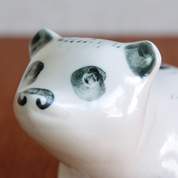 Detail showing the face on a large porcelain money box in the form of a seated bear, designed by Susan Parkinson circa 1952.