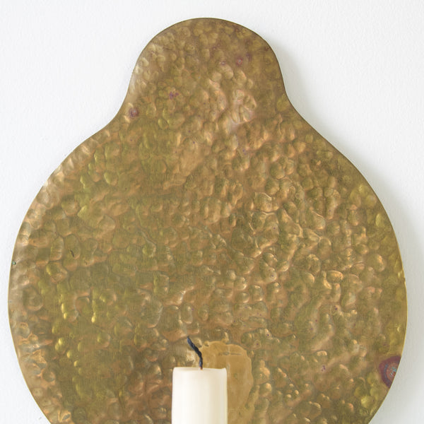 Rustic elegance meets vintage charm in this hammered brass wall sconce from Sweden.
