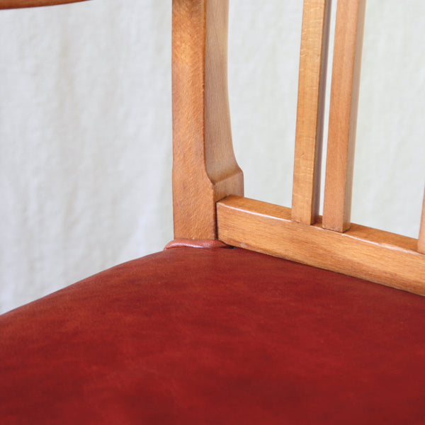 Close-up detail of a restored 1942 Ole Wanscher Model 1675 chair showing the natural variation and warm honey-yellow colour of the original beech frame.