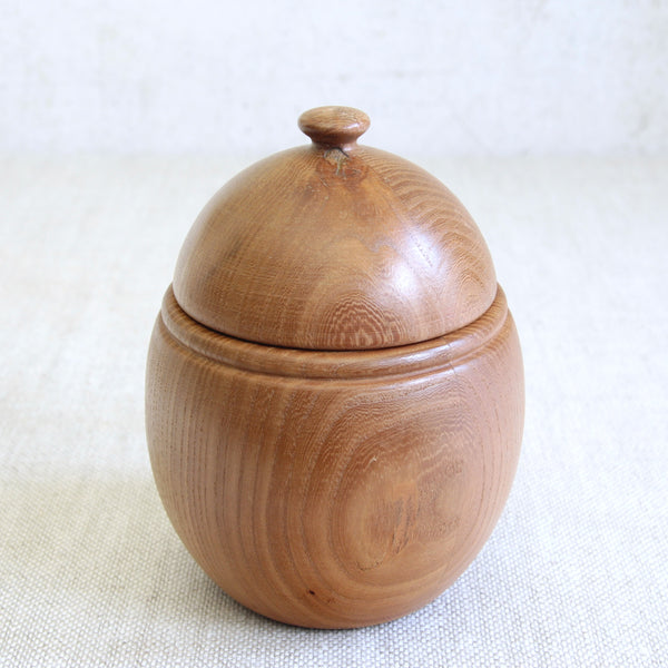 Top down view of Erik Höglund wooden storage box in acorn form for Boda Tra, highlighting Småland pine grain and mid-century Scandinavian design values.