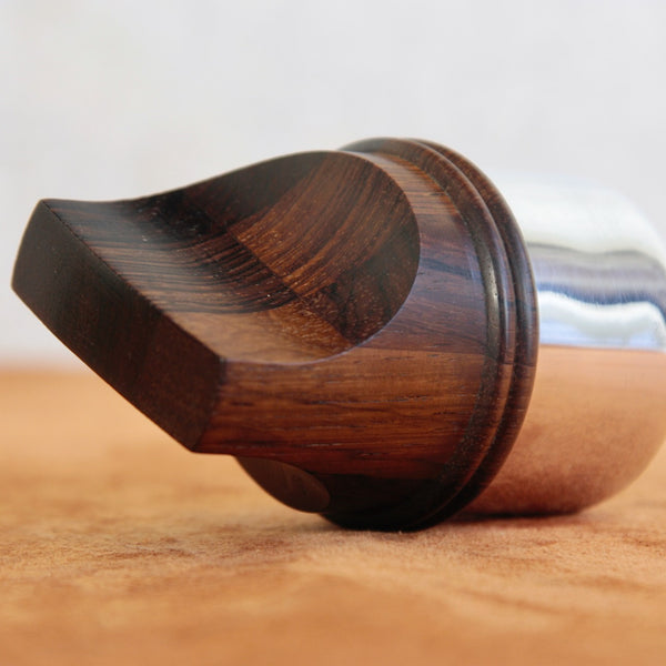 Zoomed in image showing amazing rosewood wood grain on a mid-century pepper mill designed by Jens Quistgaard for Dansk Designs, combining functional form with sculptural elegance.