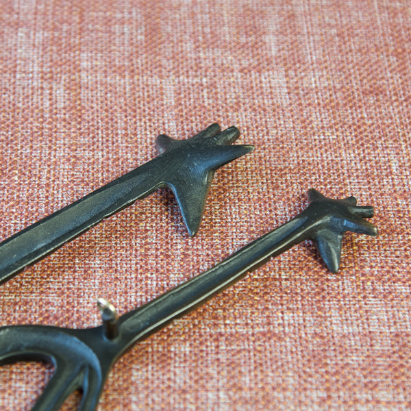 Zoomed in image showing the excellent hand finished surface on a pair of black patinated brass giraffe art pieces. Design by Walter Bosse. Production by Herta Baller, Austria, 1950s.
