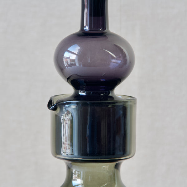 Zoomed in image of the midriff of a Kaj Franck 'Kremlin Kellot' or 'Kremlin Bells' decanter in purple glass.