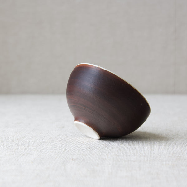 brown glaze of Friedl Holzer-Kjellberg porcelain tea bowl, with visible brushstrokes.
