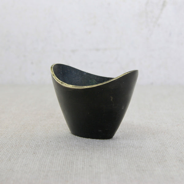 Black patinated brass vessel designed by Walter Bosse and crafted by Herta Baller, prized among international collectors.