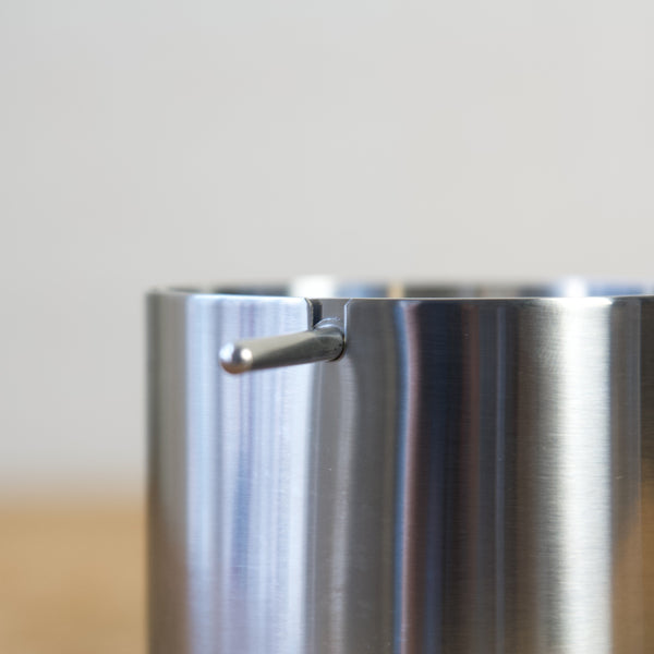 Close-up of the Stelton Cylinda-Line ashtray showing the semi-spherical rotating lid